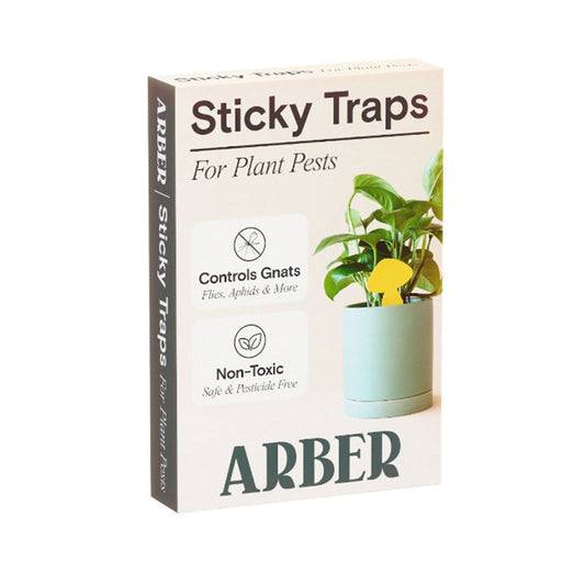 White box of ARBER Sticky Traps for Plant Pests, showing a yellow butterfly-shaped trap in a potted plant.