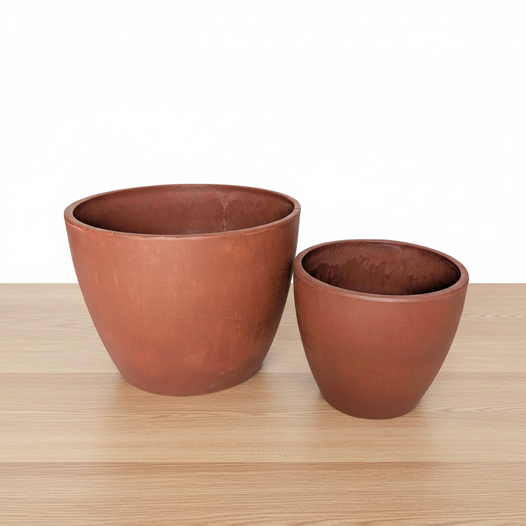 Two terracotta pots on a white background