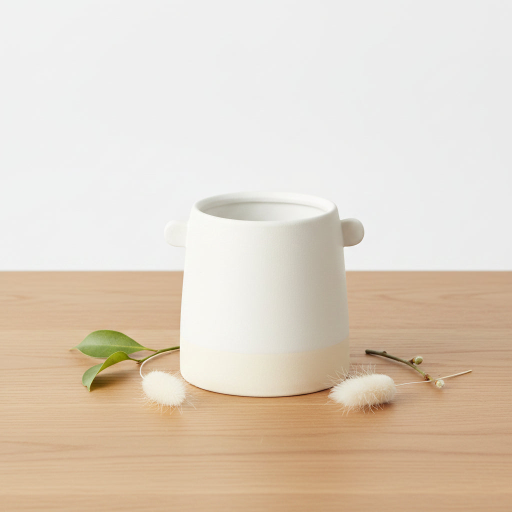 White ceramic 5-inch cylinder pot with two knobs and a natural base.