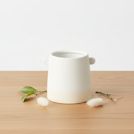 White ceramic 5-inch cylinder pot with two knobs and a natural base.