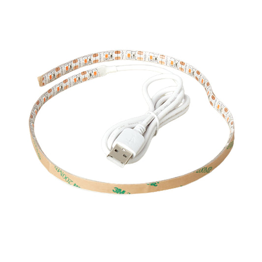 White LED flexible grow light strip with orange lights and a USB plug, coiled on a white background.