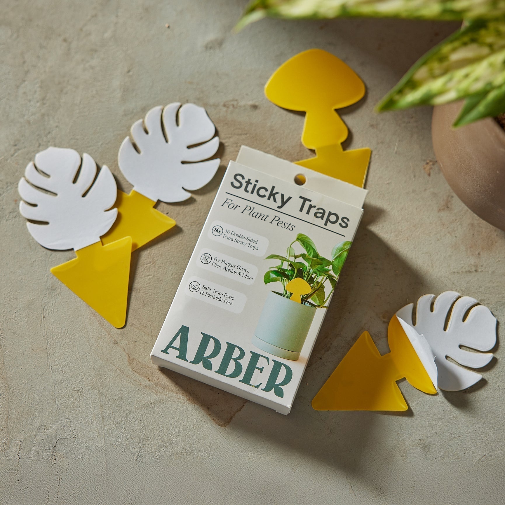 Arber Sticky Traps for Plant Pests: yellow mushroom and leaf-shaped traps, with white paper backing, next to the product box.