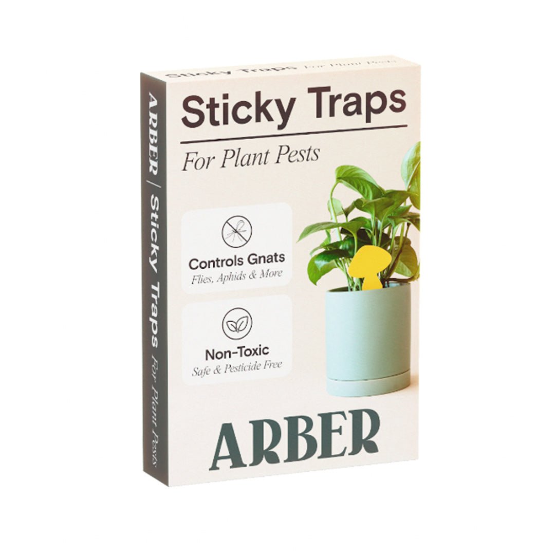 White box of ARBER Sticky Traps for Plant Pests, showing a yellow butterfly-shaped trap in a potted plant.